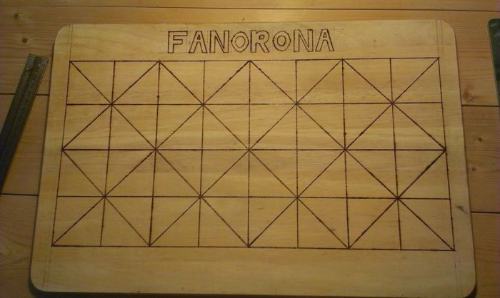 Our home made Fanorona board. Made on a chopping board using a soldering iron to brand.