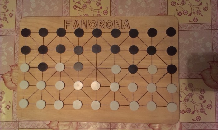 The starting set up of Fanorona on or home made board.