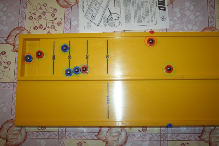 The ones circled in Red don't score as either they fall short of the scoring zone or they fell into the pit. The ones circled in Green score, even if they over hang the end and the ones circled in orange score the lower points of the two zones they cover.