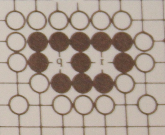 Because Blacks army has two Eyes, there are now no circumstances under which it can be captured.