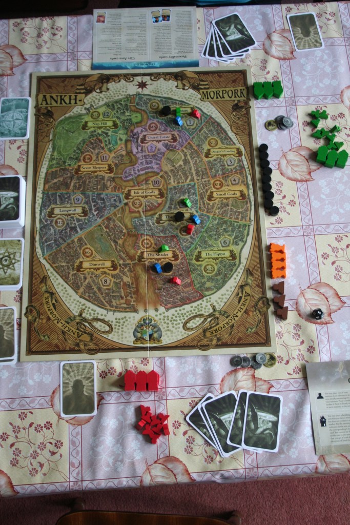 You can't see the actual numbers or names of the areas the board's divided into in this picture, but you can see the minions we  had on the board to start, and that there's a trouble marker in each area with them. Which is good enough for now.