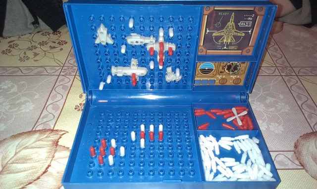 The red pegs mark hits and white pegs mark misses. The top grid shows your battleships and the hits and misses your opponent has made and the bottom grid shows the hits and misses you have made.